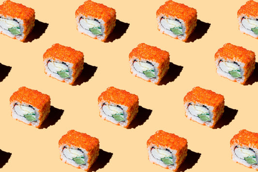 a pattern of sushi rolls on a yellow background