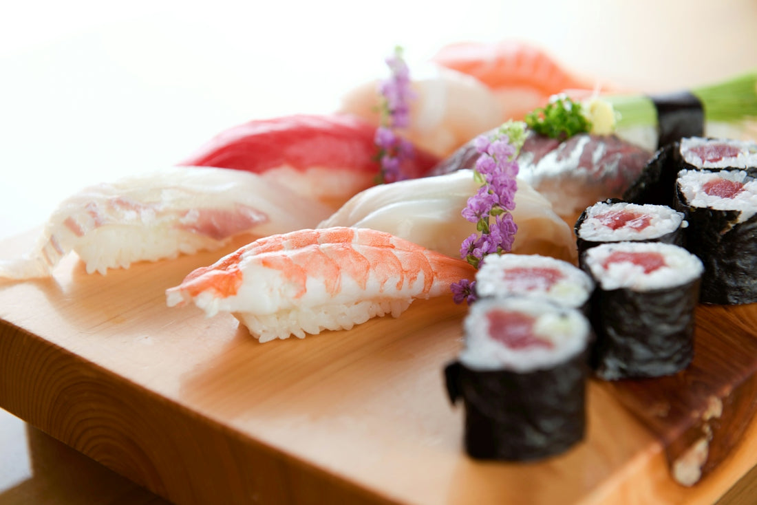 A wooden table topped with lots of sushi