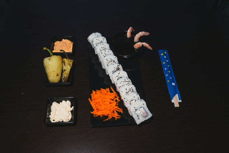 A black table topped with different types of sushi